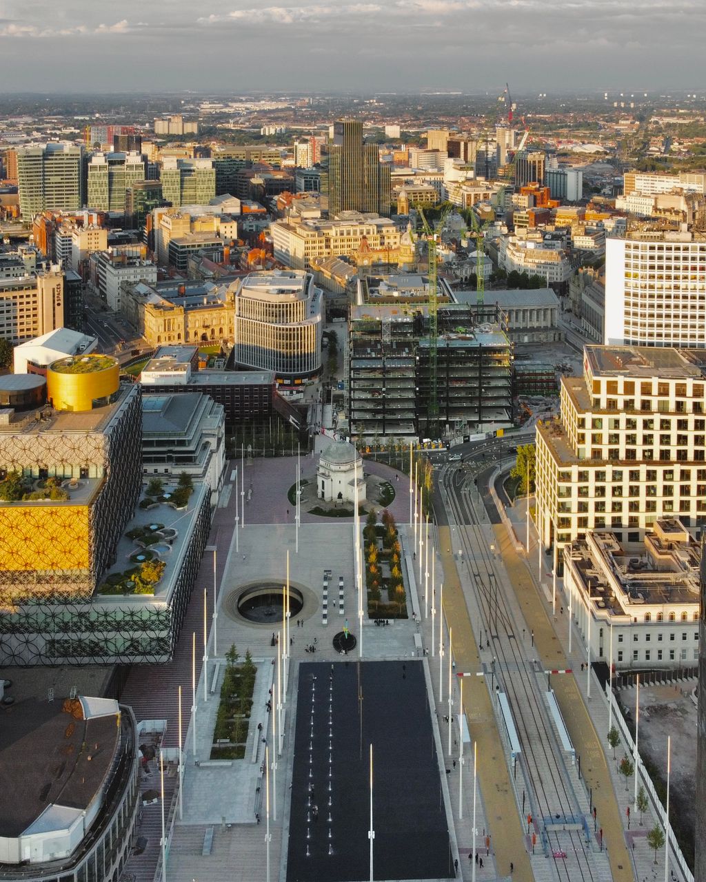 A high view over Centenary Square and Broad Street, with tram tracks running through the newly paved square and the city beyond.