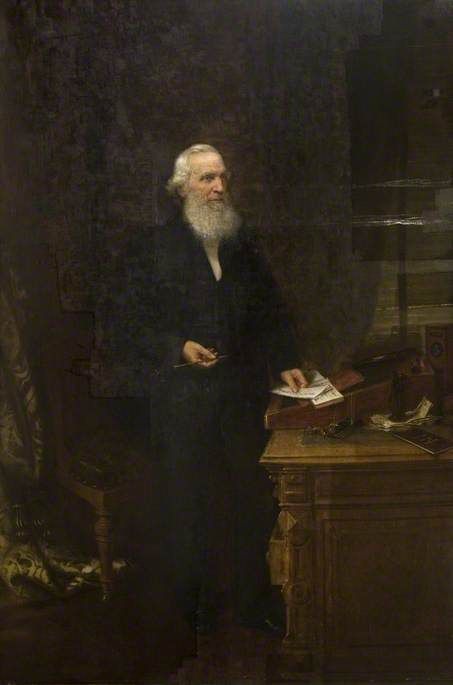 Painting of Josiah Mason as an old man with a long white beard, standing in a dark coat beside a desk with papers.