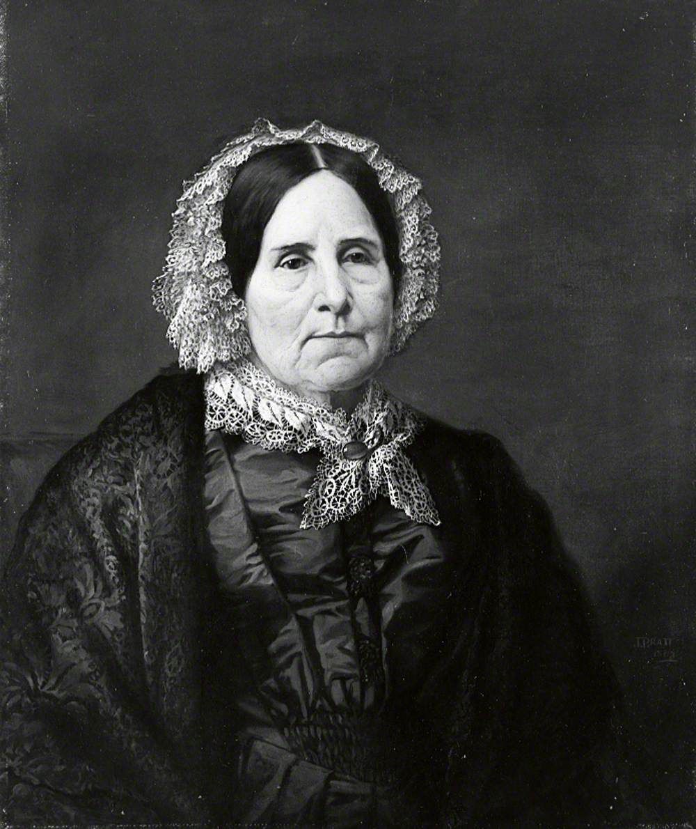 Portrait of an elderly woman in a white lace cap and a dark dress with a lace collar.