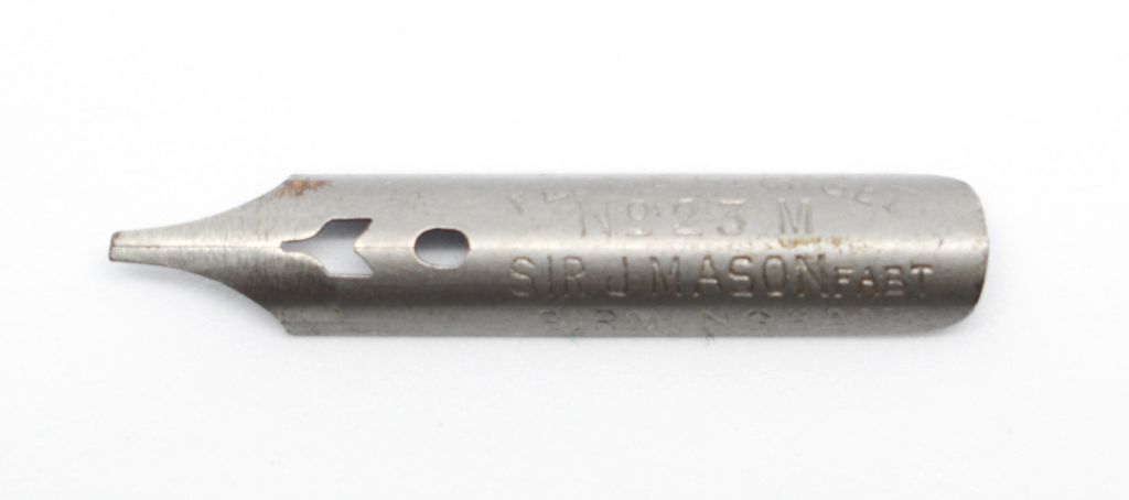 Close-up of a single steel pen nib stamped No. 23 M and Sir J. Mason.