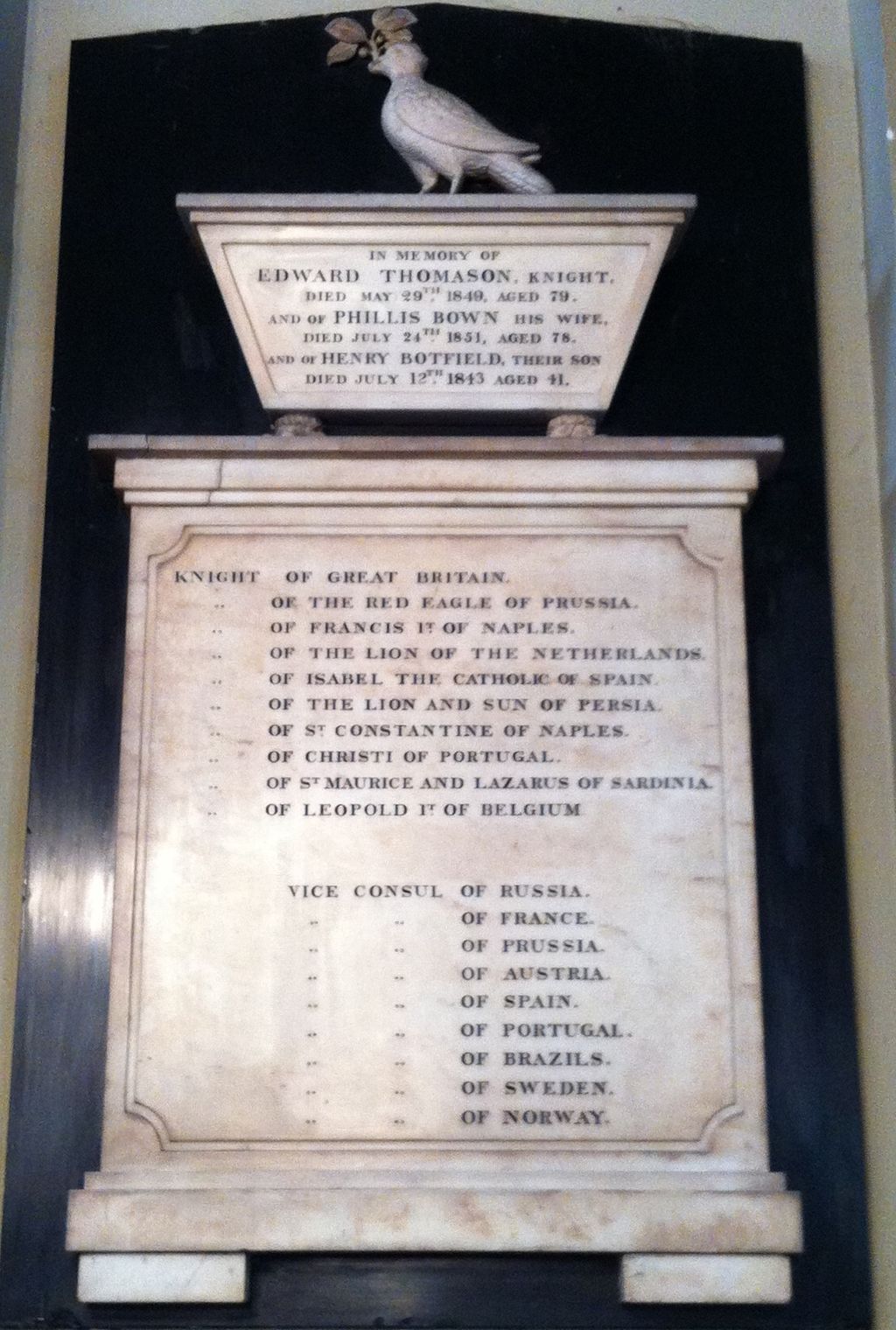 Carved stone wall memorial inside a church.