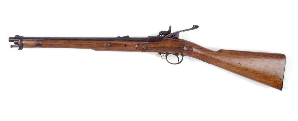 A short wooden-stocked carbine photographed side-on against a white background.