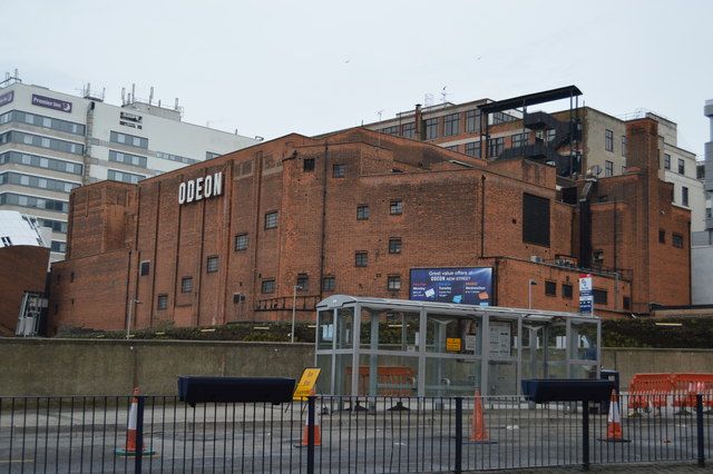 A brick 1930s cinema building on New Street with the Odeon name on its front.