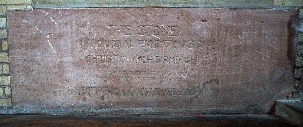 An inscribed foundation stone set inside a church.