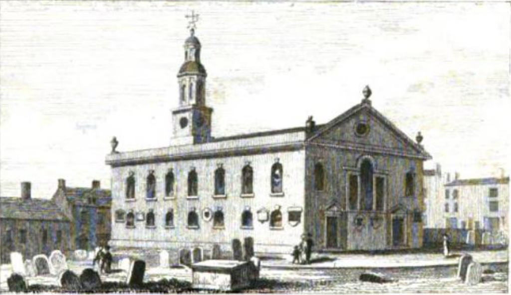 Engraving of a plain brick Georgian church with two rows of arched windows, a pedimented gable with urns and a small domed clock turret, among gravestones.