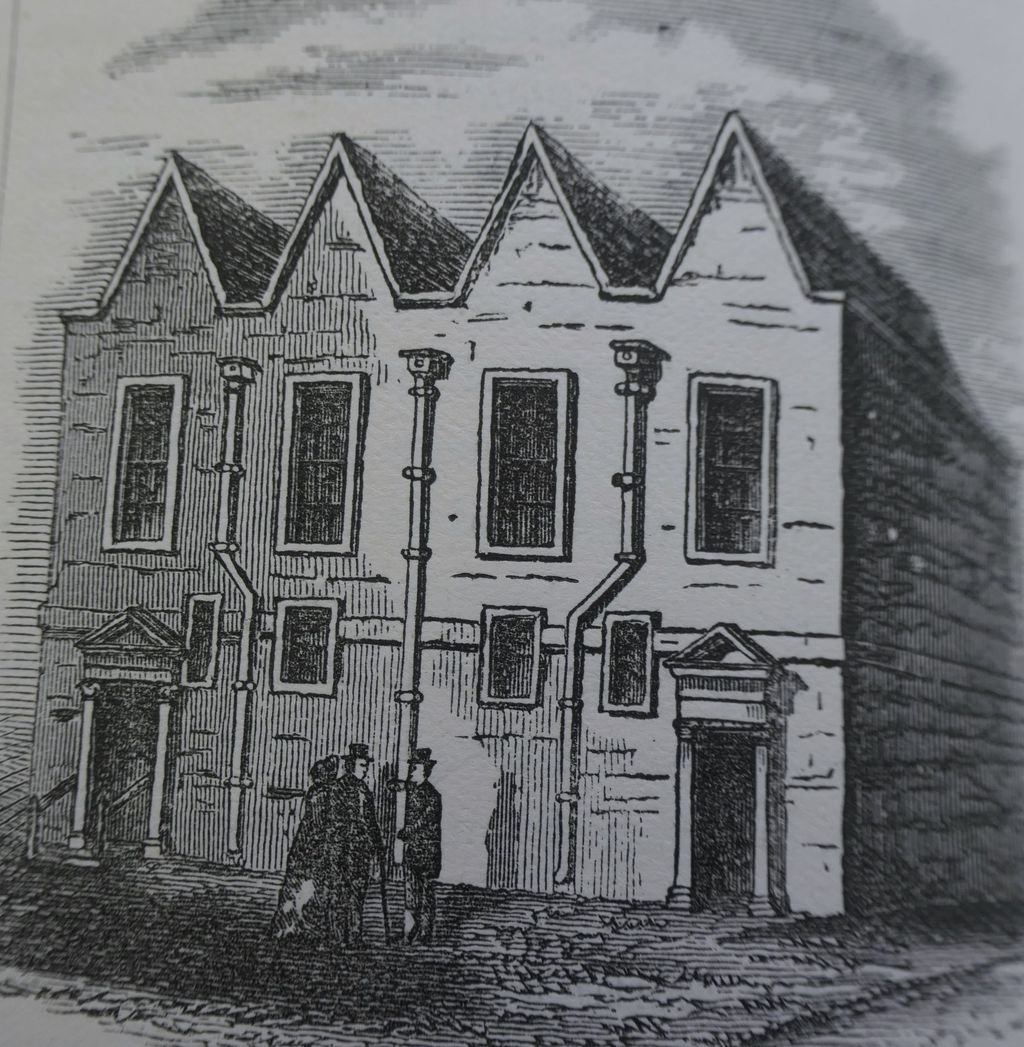 Engraving of a plain meeting house with four small gables and two pedimented doorways.