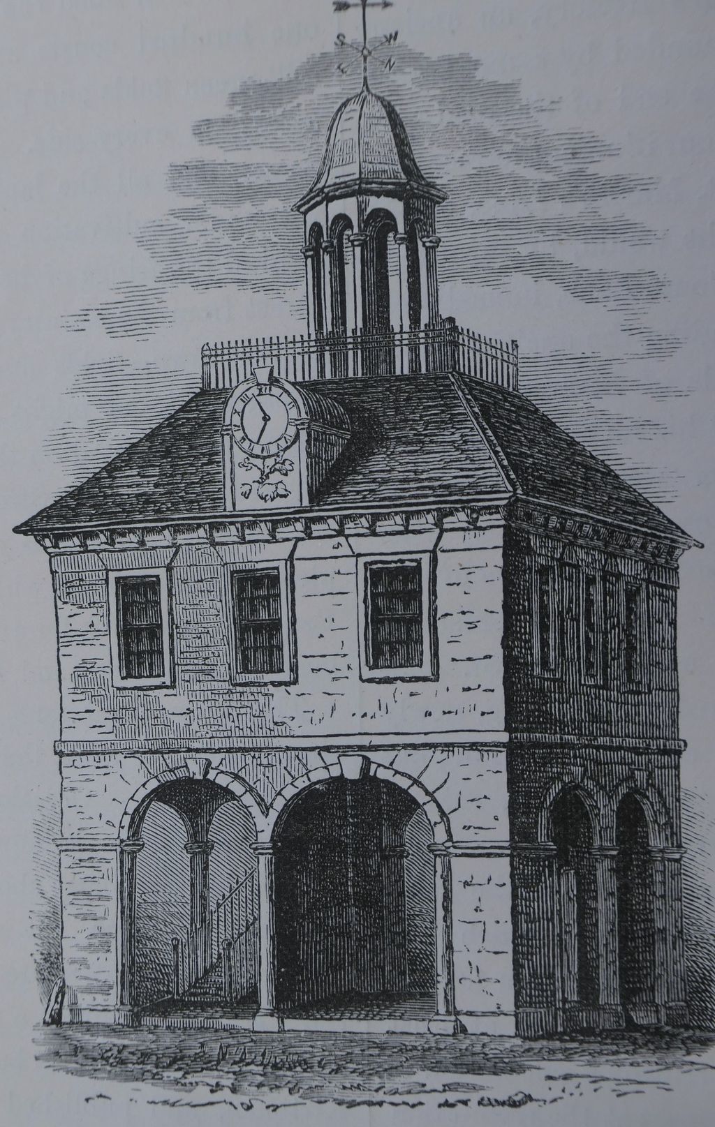 Engraving of a small square two-storey market house with open arches below, sash windows above, a hipped roof, a clock and a cupola.