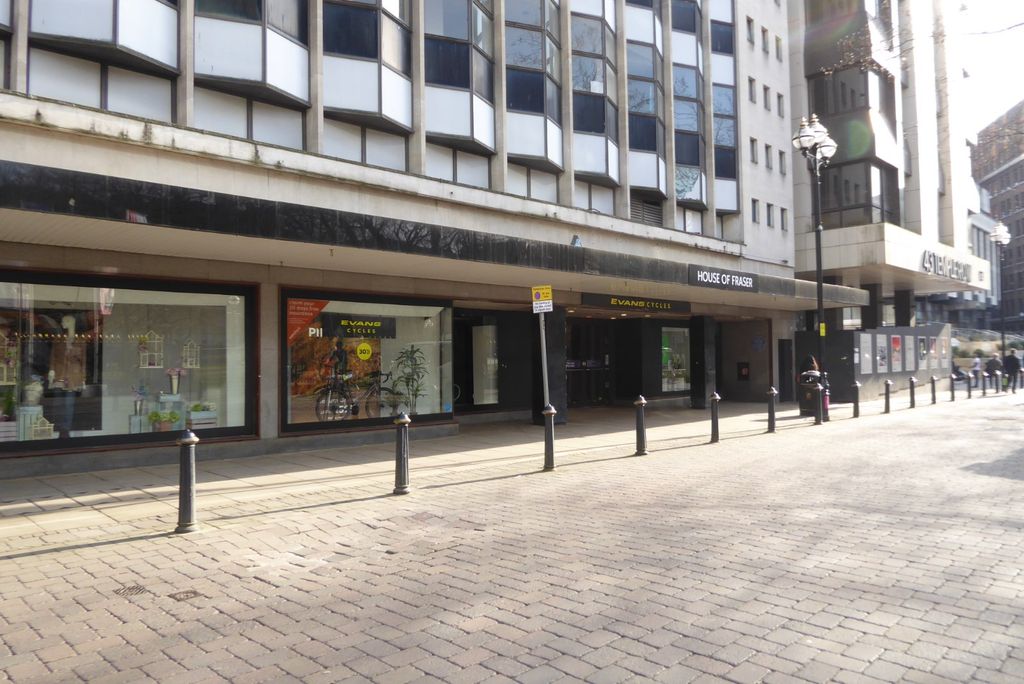 A large post-war department store building on a city street.