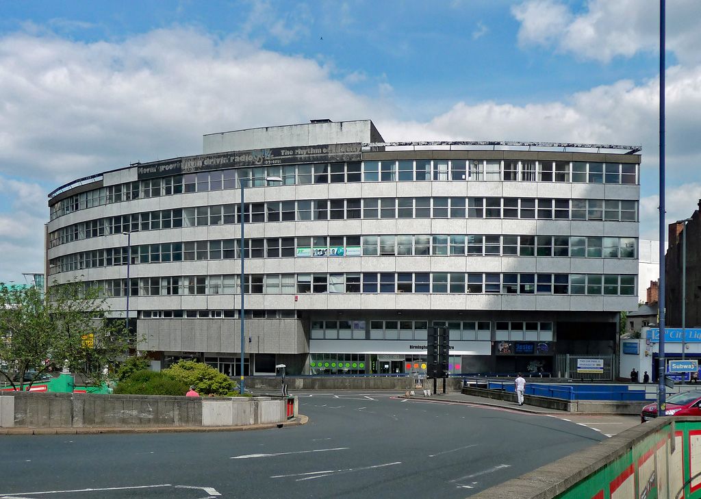 A 1960s office block on a busy city road.