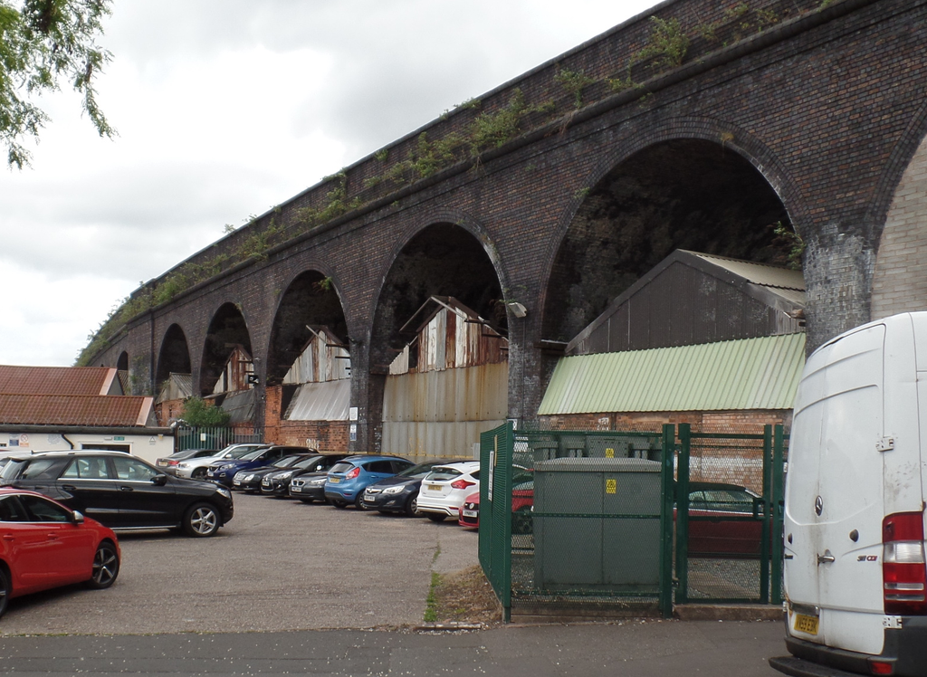 Brick railway arches over a Digbeth street.