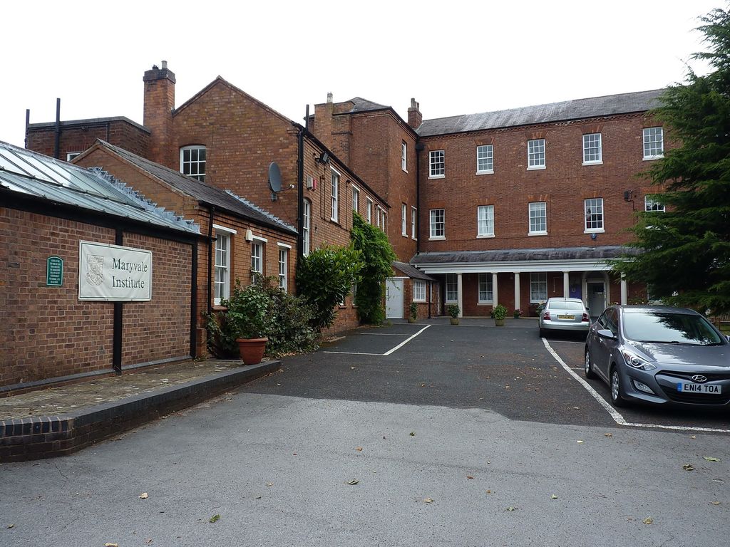 Three-storey Georgian red-brick house with sash windows and later wings around a courtyard, with a 'Maryvale Institute' sign